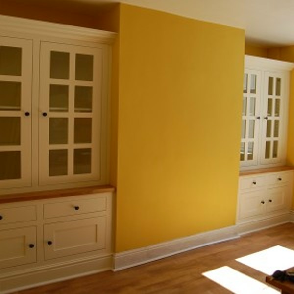 white painted alcove units with solid oak tops and glazed doors