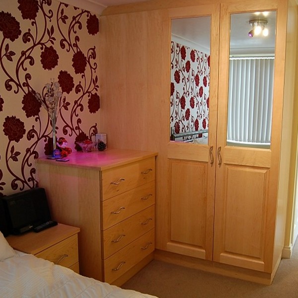 bedroom with solid beech doors and drawers with mirrored panel to doors
