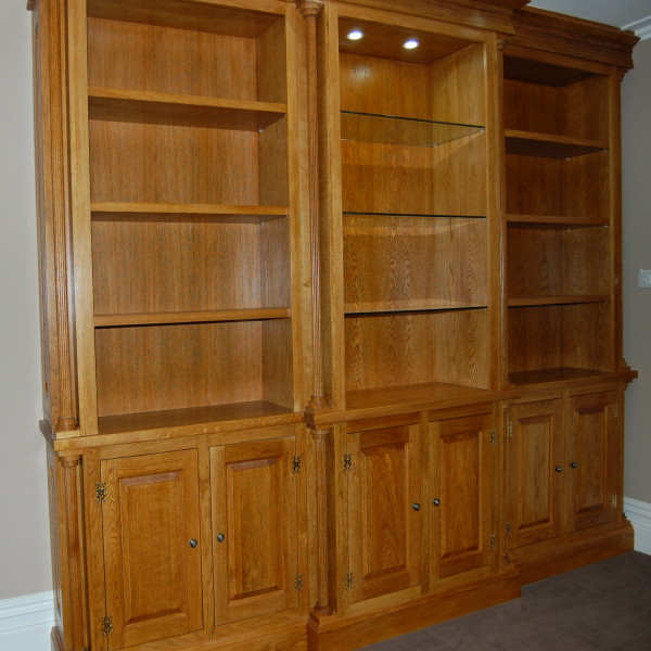 traditional bespoke solid oak unit with both solid oak and glass shelves with recessed lighting and swan hinges in a clear lacquer finish traditional bespoke solid oak unit with both solid oak and glass shelves with recessed lighting and swan hinges in a clear lacquer finish