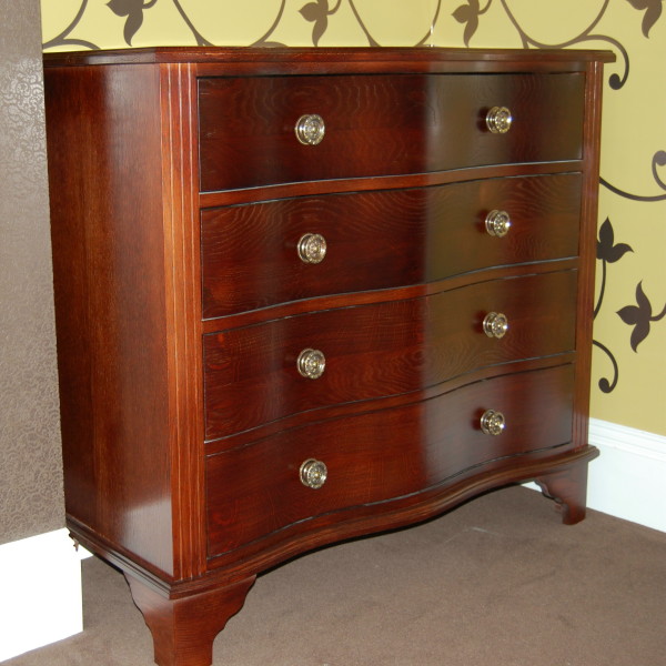 solid oak bedroom chest of drawers in a mahogany stain with a curved serpentine detail solid oak bedroom chest of drawers in a mahogany stain with a curved serpentine detail